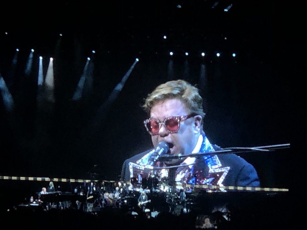 Elton John performing on stage at the concert