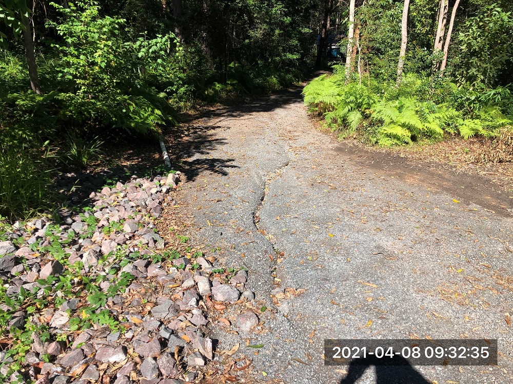 Deep rut in tenant driveway in wet weather