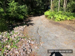 Deep-rut-in-tenant-driveway-in-wet-weather