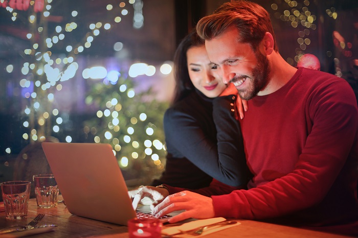 About asset agents property management. This is a photo of a happy couple in front of a laptop