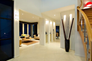 Modern home in Sunshine Coast showcasing a sleek staircase and a cozy living room area with white paint.