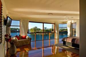 Real Estate Appraisal : A photo of a large main bedroom on the sunshine coast featuring large windows and a view of clean canal
