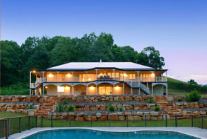 A charming and spacious house featuring a pool and expansive deck.