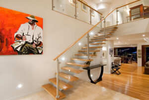 A staircase adorned with a painting, accompanied by a beautiful interior design