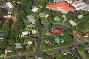 An aerial view of a Sunshine Coast community, showing houses surrounded by lots of greenery and trees, highlighting the peaceful, nature-filled environment.