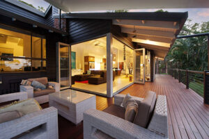A beautifully furnished deck on the Sunshine Coast, showcasing a glass door that enhances the outdoor living space.