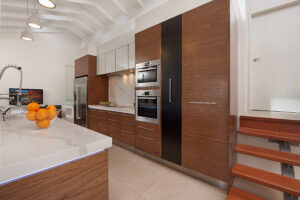 A photo of a well-appointed kitchen located on the Sunshine Coast residence, featuring essential appliances: a refrigerator, stove, and sink.