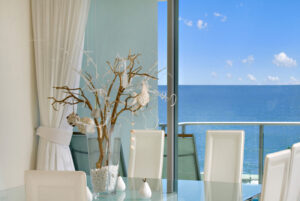 Elegant dining room with expansive windows offering a picturesque view of the ocean in Sunshine Coast region