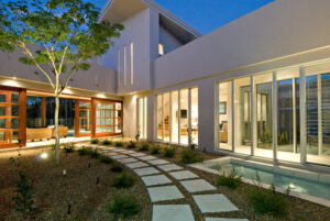 Nighttime scene of a walkway in front of a house on the Sunshine Coast, featuring soft lighting and a peaceful atmosphere