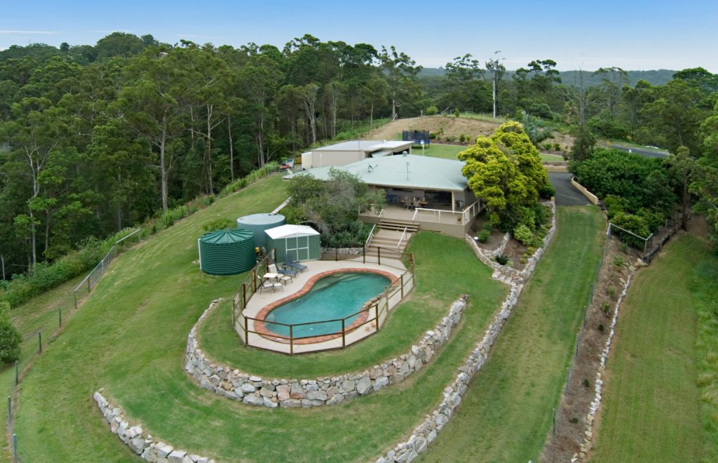 Sell my House for Cash: A Comprehensive Guide Bird's-eye view of a home with a pool and surrounding trees, capturing the essence of the Sunshine Coast landscape.